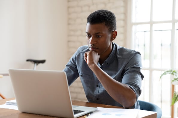 person working on a customer data management strategy plan on a laptop